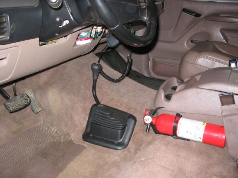 1995 Ford Bronco - The interior of a 1992 Ford Bronco, a manual transfer case shifter and a fire extinguisher.