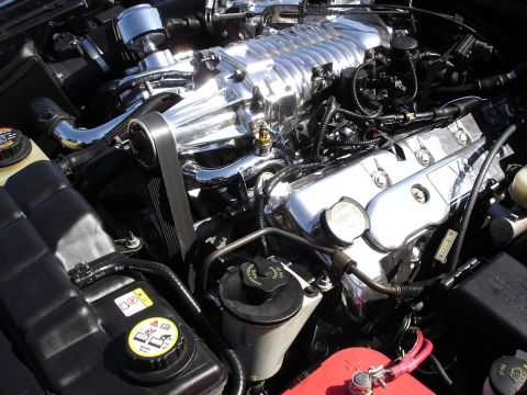 1998 Ford Taurus - Close-up view of a highly polished engine a supercharger and chrome valve covers.