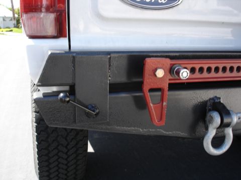1996 Ford Bronco - Custom rear bumper features a red Hi-Lift jack mount and a heavy-duty tow hook, with visible "SUPERMOTORS.NET" text.