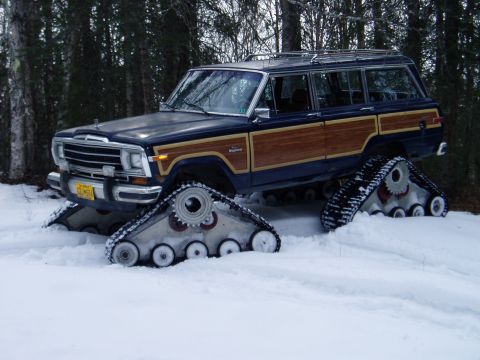2000 Ford E350 - This modified Jeep Grand Wagoneer is equipped with tank treads for traversing snowy terrain.