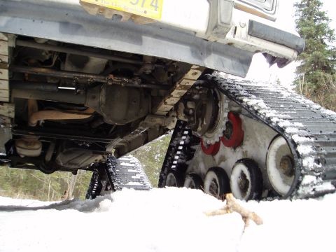 2000 Ford E350 - Vehicle equipped with snow tracks for off-road winter travel.