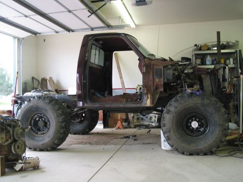 1981 Ford Bronco - This custom truck chassis features oversized tires and a maroon cab, appearing to be in the midst of a significant build or modification pr…
