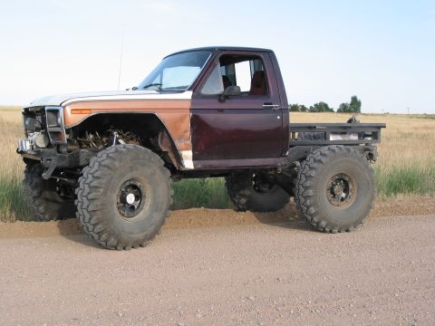 1981 Ford Bronco - This heavily modified pickup truck features oversized tires and a custom flatbed conversion.