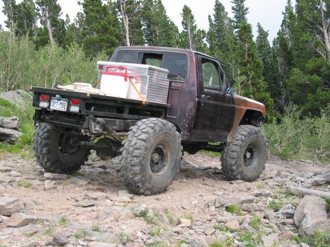 1981 Ford Bronco - This heavily modified truck is equipped for off-road use with oversized tires and a custom flatbed.