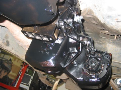 1981 Ford Bronco - Underside view of a vehicle's transfer case and linkage system.