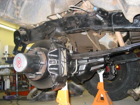 1981 Ford Bronco - The rear suspension and braking system of a vehicle are shown, with the axle and leaf springs clearly visible.