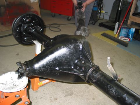 1981 Ford Bronco - A rear axle assembly is shown on jack stands in a garage setting.