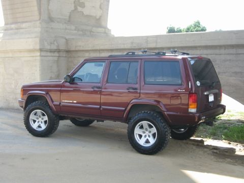 2000 Jeep Cherokee - This lifted Jeep Cherokee features aftermarket wheels and a dark maroon paint job.