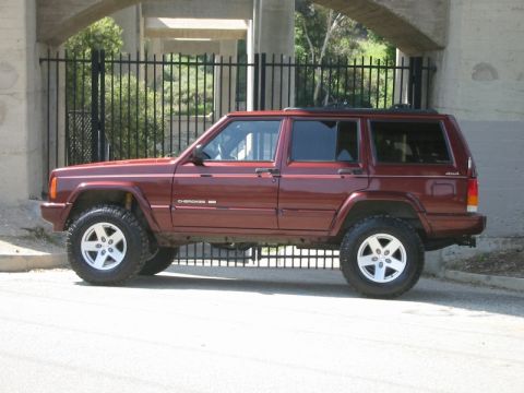 2000 Jeep Cherokee - This lifted 2000 Jeep Cherokee is shown from the side, aftermarket wheels and tires.