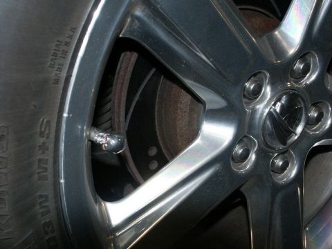 2001 Mercury Grand Marquis - A close-up view of a vehicle's wheel, tire, and brake rotor.