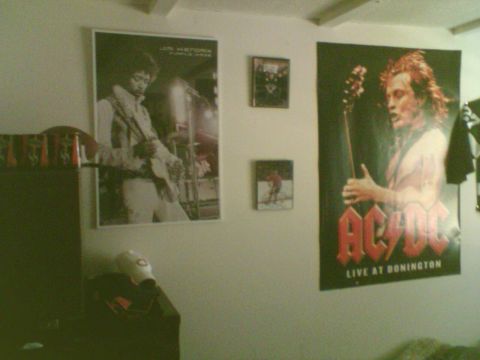 1985 Ford F-150 - A room decorated with music memorabilia, including large posters of Jimi Hendrix and AC/DC.