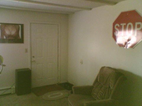 1985 Ford F-150 - This image shows an indoor scene a stop sign and a framed picture, with no vehicles visible.