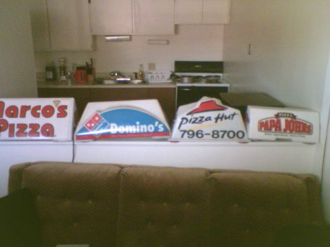 1985 Ford F-150 - A collection of pizza boxes from various popular chains are displayed in a room.