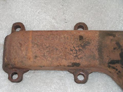 1967 Ford Galaxie - Close-up of a rusty exhaust manifold with visible part numbers, not a complete vehicle.