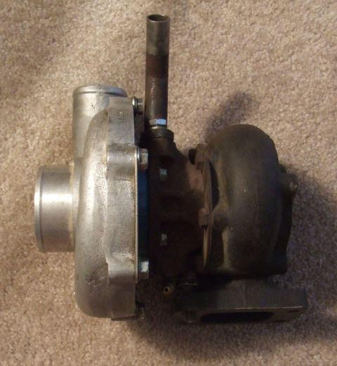 1995 Ford Probe - Turbocharger part shown on a carpeted surface.