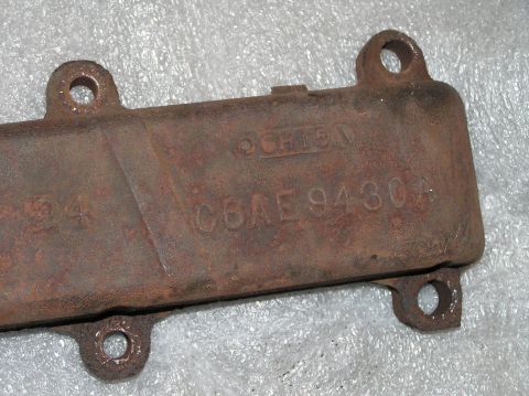 1967 Ford Galaxie - A close-up view of a corroded metal component with embossed part numbers and identifiers.