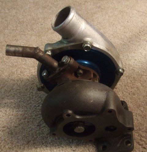 1995 Ford Probe - Turbocharger part shown on a carpeted surface.