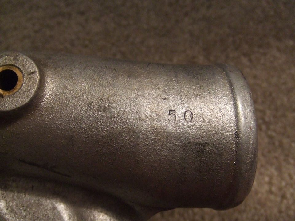 Close-up of a metal pipe with the number 50 stamped on it