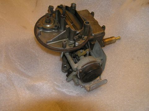1967 Ford Galaxie - A close-up view of a carburetor, a critical engine component for fuel and air mixture.