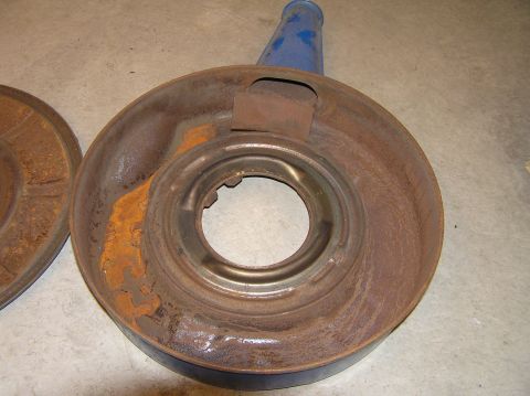 1967 Ford Galaxie - Two heavily rusted air cleaner components, one with a blue snorkel, sit on a concrete floor.