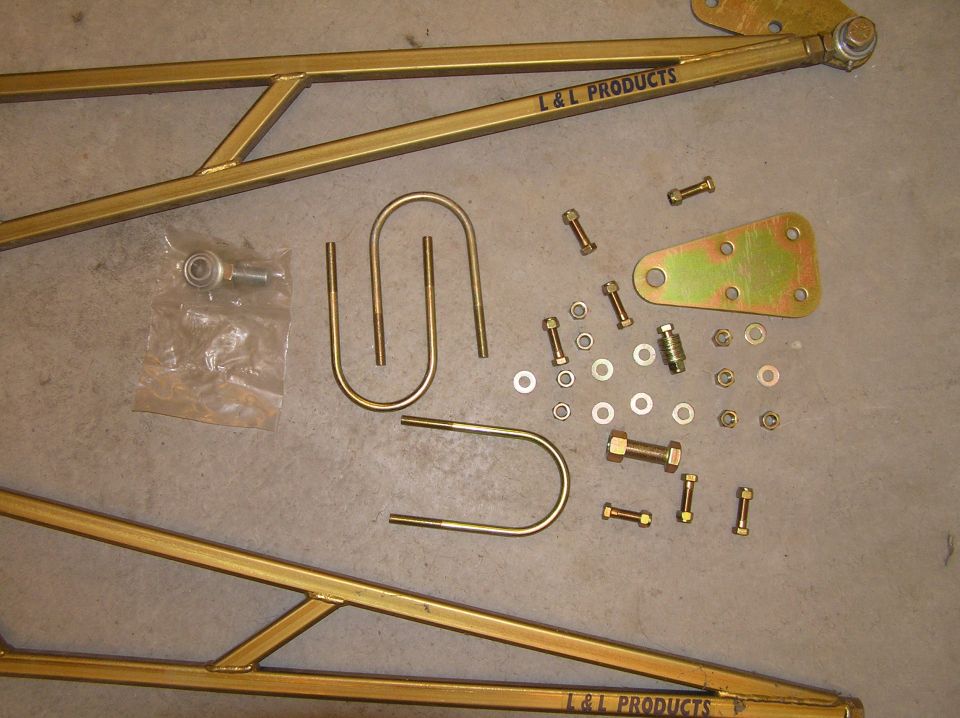 Gold L&L Products suspension arm kit with U-bolts, bracket, and hardware on concrete