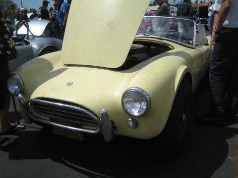 1968 Ford Mustang - Front view of a yellow convertible sports car at a car show.