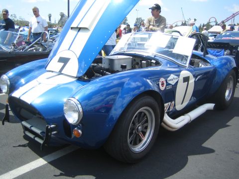 1968 Ford Mustang - A blue Shelby Cobra with its hood open, displaying racing stripes and the number 7.