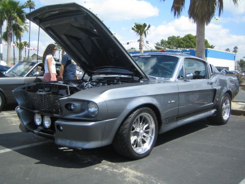 1968 Ford Mustang - This 1967 Shelby GT500 Mustang is shown with its hood open, revealing the engine bay and a prominent "GT 500" decal on the side.