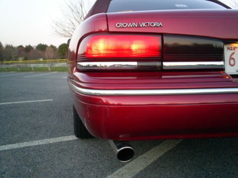 1995 Ford Crown Victoria - Rear view of a red 1995 Ford Crown Victoria showing the taillight and bumper details.