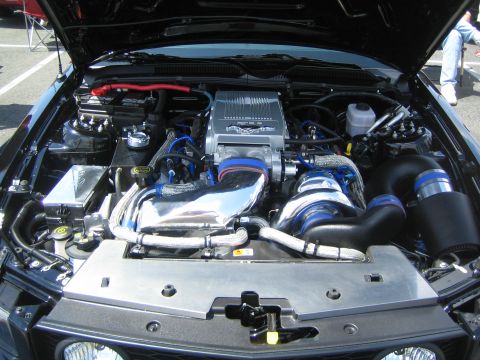 1968 Ford Mustang - Modified engine bay of a modern Ford Mustang a prominent supercharger and custom intake piping.