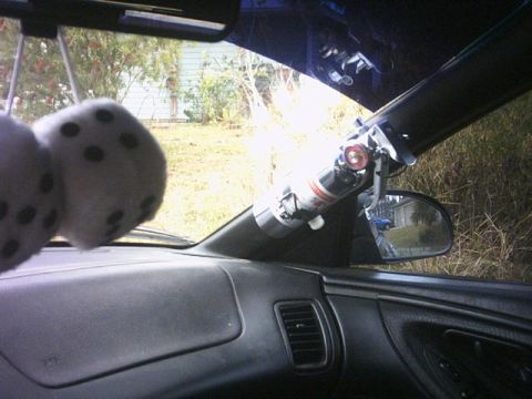 1994 Ford Probe - A fire extinguisher is mounted near the windshield pillar, with fuzzy dice visible on the left.