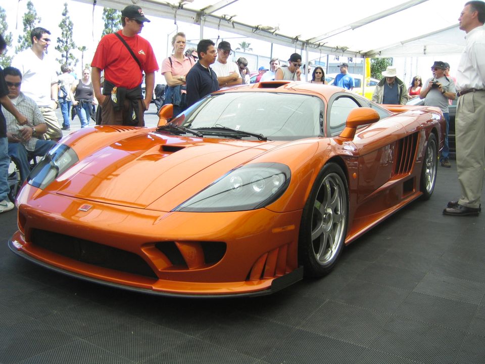 Orange Saleen S7 sports car with people looking at it