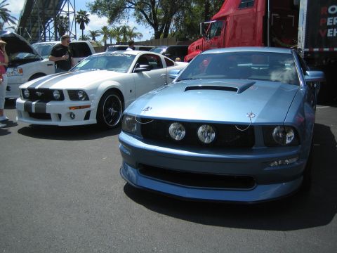 1968 Ford Mustang - Two Ford Mustangs are parked side-by-side at an outdoor car show.