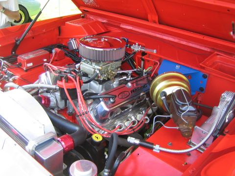 1968 Ford Mustang - Close-up of a Ford V8 engine, chrome components and red spark plug wires.