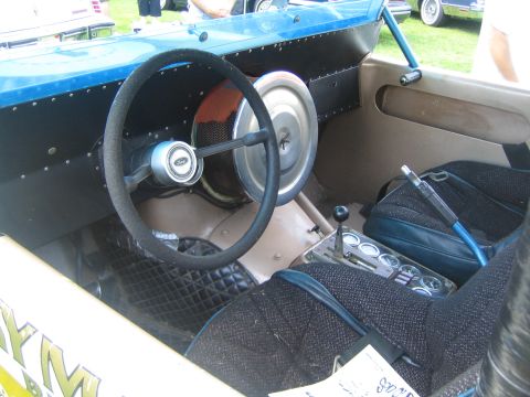 1968 Ford Mustang - Custom drag car interior features a Ford steering wheel and racing seats.