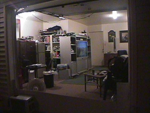 1994 Ford Bronco - A cluttered room interior is visible, shelves filled with items, a television, and various furniture pieces.