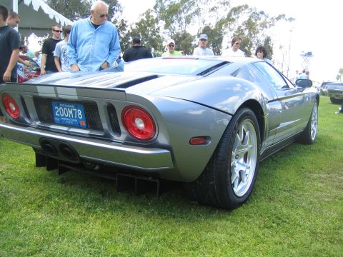 1968 Ford Mustang - Rear view of a gray Ford GT on display at an outdoor car show.