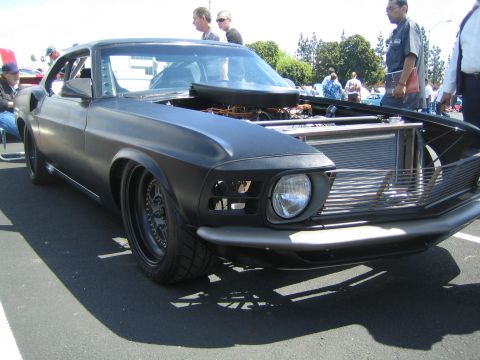1968 Ford Mustang - This 1969 Ford Mustang features a matte black finish and its hood is open, revealing the engine and radiator.