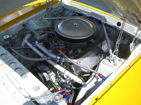 1968 Ford Mustang - Customized engine bay with braided hoses and a large air filter, likely for racing or performance modification.
