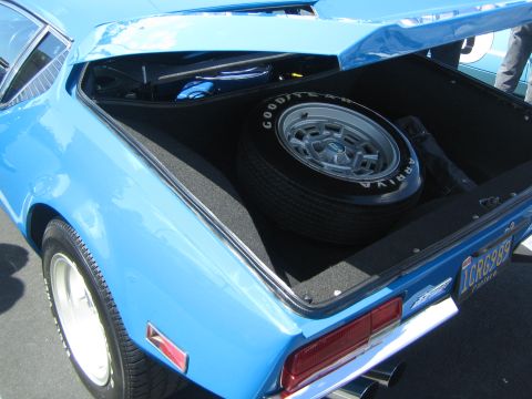 1968 Ford Mustang - The trunk of a blue coupe reveals a spare tire with a Good Year Arriva tire. The license plate is visible.