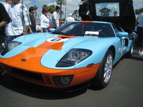 1968 Ford Mustang - A modern Ford GT sports car with Gulf livery is displayed at an event.