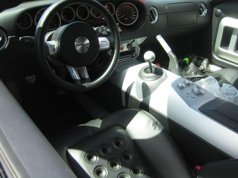 1968 Ford Mustang - The interior of a Ford GT shows its sporty design with a prominent gear shifter and dashboard.
