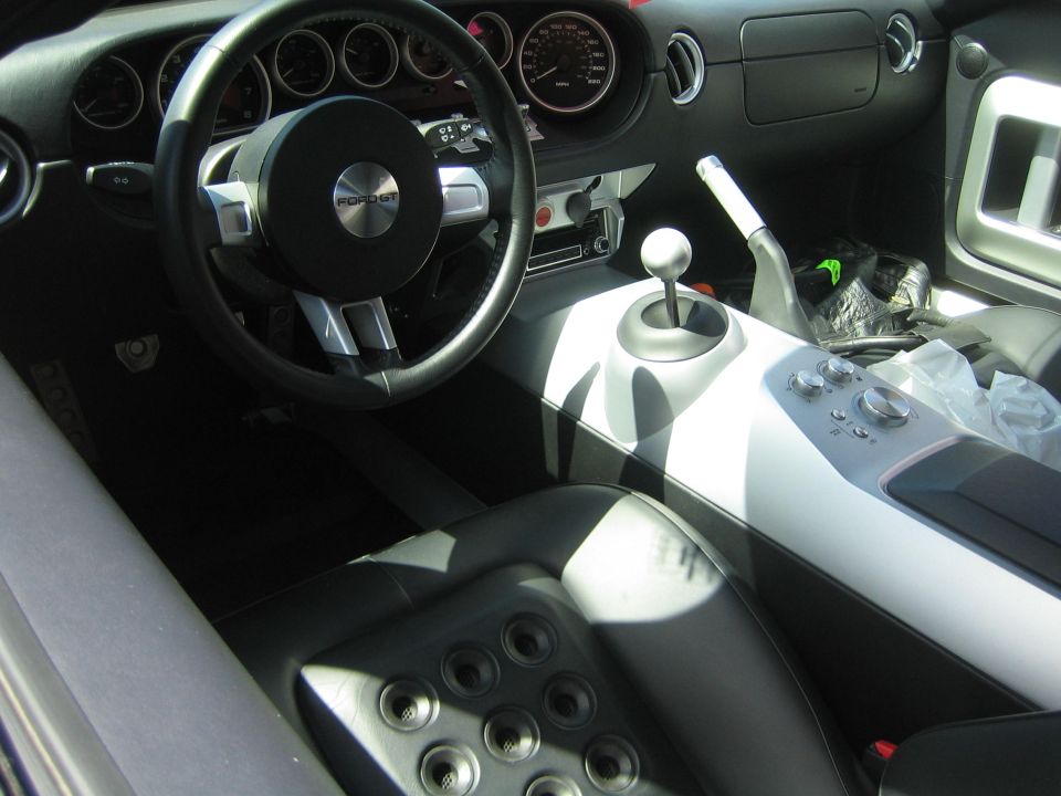 Interior view of a Ford GT with a black leather seat and a central console