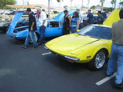 1968 Ford Mustang - Two sports cars are displayed with hoods open at an outdoor car show.