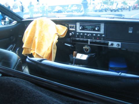 1968 Ford Mustang - Interior view of a car with a yellow towel draped over the dashboard and an aftermarket radio.