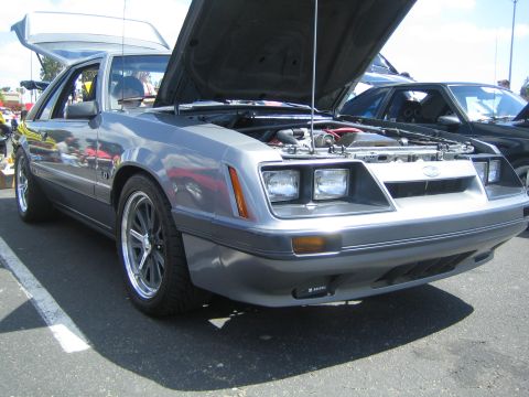 1968 Ford Mustang - This silver Ford Mustang 5.0 is displayed with its hood and trunk open, revealing the engine bay and interior.