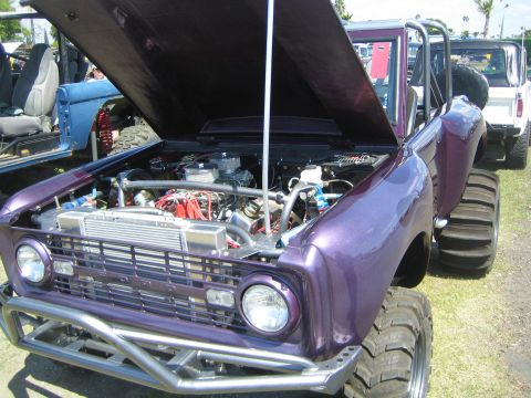 1968 Ford Mustang - Customized 1968 Ford Bronco with engine exposed, parked next to another Bronco.