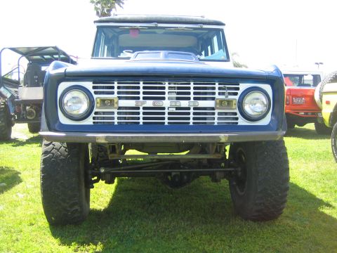 1968 Ford Mustang - Front view of a blue 1968 Ford Bronco, its distinctive white grille with 'FORD' lettering and prominent headlights.