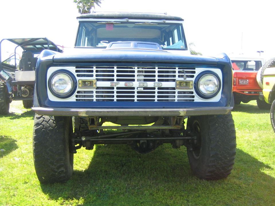 Blue 1968 Ford Bronco front view with white grille and 'FORD' lettering