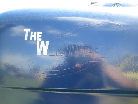 1968 Ford Mustang - A close-up of a blue vehicle's exterior shows embossed text and design elements.